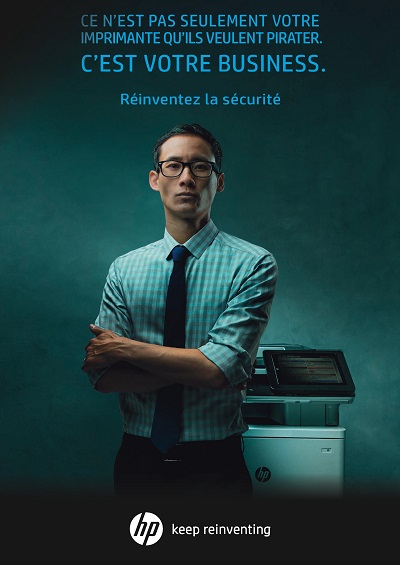 man standing by the most secure printer in the world which is made by hp